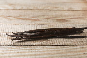 Vanilla pods on a textured background. Vanilla flowers and seeds. vanilla stick bean. Aromatic spicy spice for pastries and desserts. Seasoning. Space for text. Copy Space
