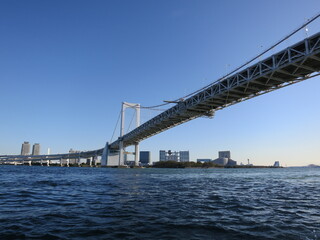 Modern suspension bridge crossing over deep blue water