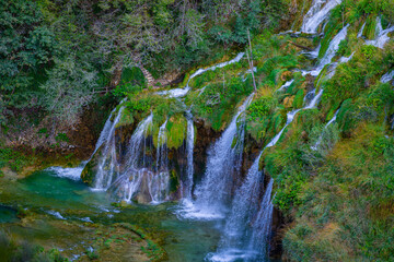Beauty in spring nature, amazing waterfall in forest. Waterfall and pond. Panoramic beautiful deep...