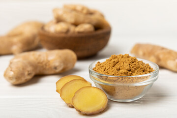 Fresh ginger on wooden background. Dry ginger. Sliced ​​ginger with honey and lemon. Ginger...