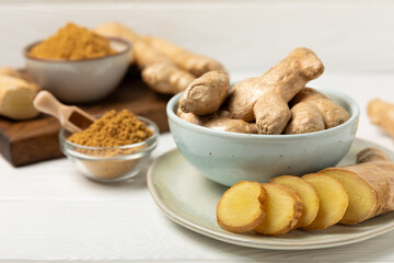 Fresh ginger on wooden background. Dry ginger. Sliced ​​ginger with honey and lemon. Ginger...