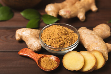 Fresh ginger on wooden background. Dry ginger. Sliced ​​ginger with honey and lemon. Ginger root. Traditional alternative medicine, healing tea for immunity. Seasoning and spices concept. Copy space.