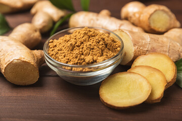 Fresh ginger on wooden background. Dry ginger. Sliced ​​ginger with honey and lemon. Ginger...