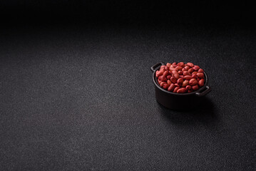 Peanuts or peeled graundnut in a bowl on a dark concrete background