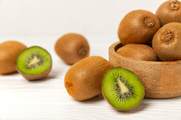 Kiwi on wooden background. Whole fruit and slices pieces of green kiwi on table. fresh ripe juicy...