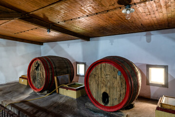 Wine barrels (botti) in a wine cellar. Old wine barrels in a wine cellar.