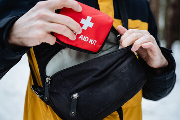 A determined individual has a wellequipped first aid kit, ready to provide immediate assistance for...