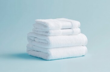 Stack of White Cotton Bath Towels Freshly Laundered on Blue Background