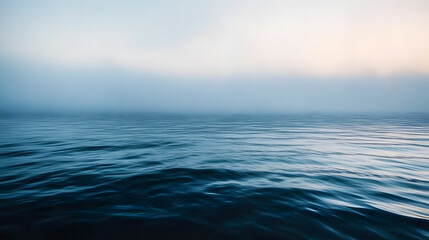 Obraz premium Tranquil and Serene Ocean Water Surface Captured During a Misty Morning&nbsp;
