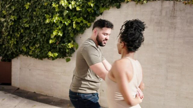 Man and woman dancing cuban salsa in an outdoor location