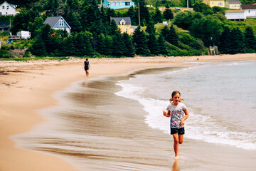 Mother and daughter walking on the beach, Cape Barton Island, Cabot trail, Nova Scotia