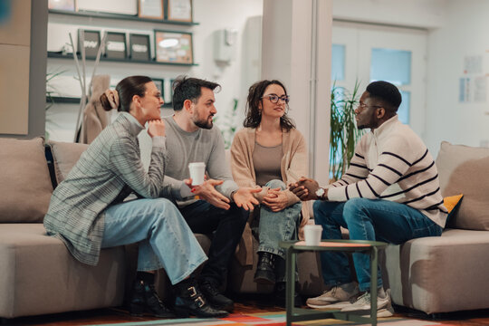 Coworkers having informal meeting, discussing new project in office lounge zone - Powered by Adobe