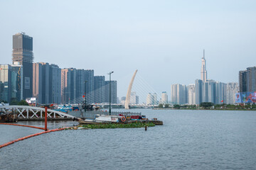 Fototapeta premium A vibrant cityscape with a captivating waterfront and impressive skyscrapers, Ho Chi Minh City