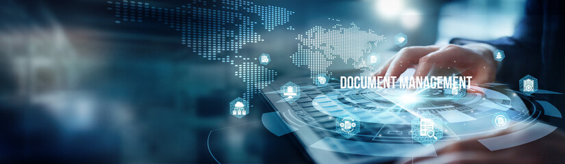 A man using a laptop analyzes files for document management. Security and accessibility features to streamline workflows improve efficiency and ensure compliance with regulatory standards effectively.