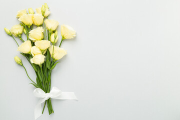 Beautiful bouquet with eustoma flowers on color background, top view