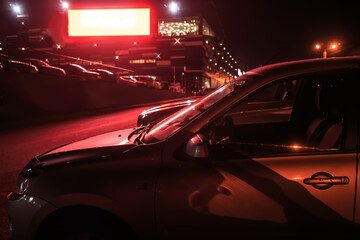 Naklejka premium Cars parked in the evening near a shopping mall