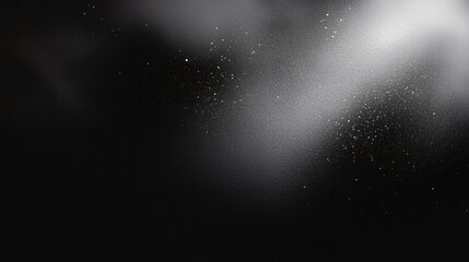 Black matte textured background with floating dust particles illuminated by soft light in the top right corner, creating a deep contrast between black and white. This abstract design emphasizes textur