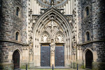 The historic St. Martinus Church in Olpe, Germany, built in neo-Gothic style, features a striking 61-meter tower and intricate architectural details, standing as a cultural landmark.