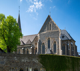 The historic St. Martinus Church in Olpe, Germany, built in neo-Gothic style, features a striking 61-meter tower and intricate architectural details, standing as a cultural landmark.
