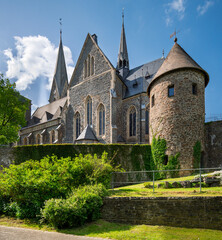 The historic St. Martinus Church in Olpe, Germany, built in neo-Gothic style, features a striking 61-meter tower and intricate architectural details, standing as a cultural landmark.