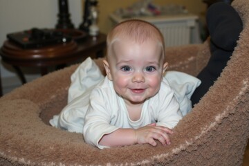 A baby laying in a dog bed smiling at the camera