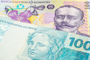 100 Romanian leu and 100 Brazilian real banknotes. International trade concept