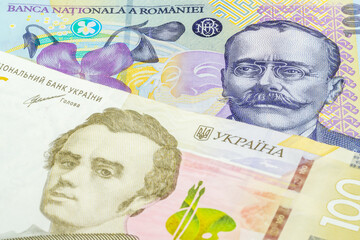 100 Romanian leu and 100 Ukrainian hryvnia banknotes. International trade concept