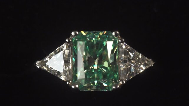 green gemstone ring on black background