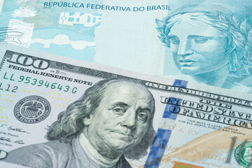 US 100 dollar and 100 Brazlilian reals banknotes. International trade concept