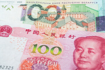 100 Belarusian ruble and 100 Chinese renminbi banknotes. International trade concept