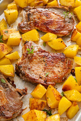 Pork chops and potatoes on a sheet pan oven roasted for an easy dinner
