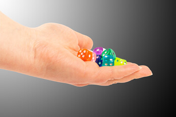 Colorful assortment of plastic dice held in an open hand during a tabletop game session