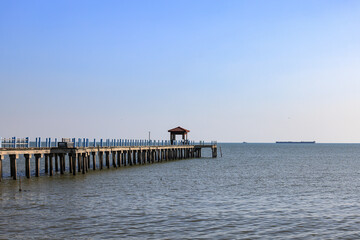 Fototapeta premium Pier at the sea, jetty and sea in sun light.