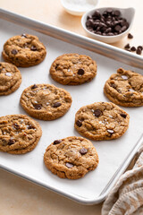 Chocolate chip cookies with pecan nuts, freshly baked cookies on a baking sheet