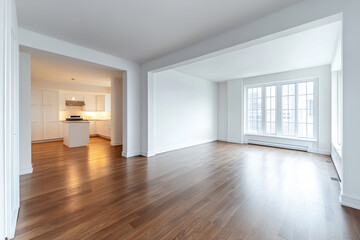 Fototapeta premium Interior view of a modern home with hardwood floors and a white kitchen visible in the background