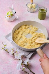 Step by step preparation of Dubai style Easter cake with kataifi dough and pistachio paste filling. Frying kataifi dough with butter in a pan. Happy Easter.