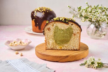 Step by step preparation of Dubai style Easter cake with kataifi dough and pistachio paste filling. Cut ready Easter cake with filling on wooden board.