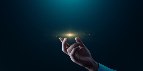 Human Hand Touching Golden Light Particles with Empty Space for Copy