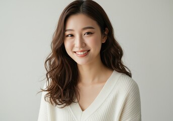 Fototapeta premium Portrait of a smiling woman with wavy hair and white top
