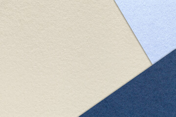 Texture of craft light beige paper background with sky and navy blue border. Vintage abstract cream cardboard.