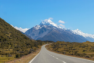 Road to Mount Cook National Park, majestic snow capped Mt Cook over road