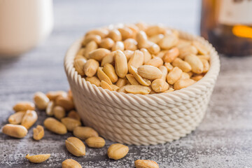 Roasted salted peanuts in bowl on kitchen table