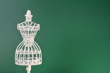 a white clothes mannequin on a green background 