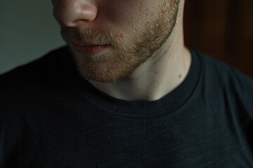 Obraz premium close up of black t shirt being worn by a young man close up at home