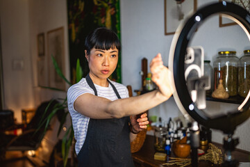 japanese woman use mobile phone and ring light present dropper bottle