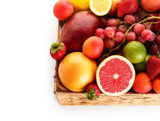 Wicker basket with different fresh fruits on white background