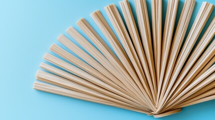 Natural rubber twist ties in a fanned pattern on a pastel blue background