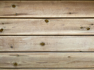 Texture from wooden boards with knots in weathered natural color. Aged background. Closeup.