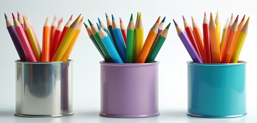Fototapeta premium Three pencil containers in rainbow colors silver blue purple. Each filled colored pencils are perfect art supplies. Stationery items on white background. Education, school, creativity and art concept.