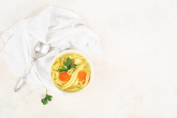 Bowl of tasty chicken soup on white background